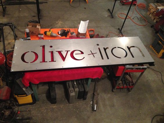 Stainless steal cut out backlit sign.